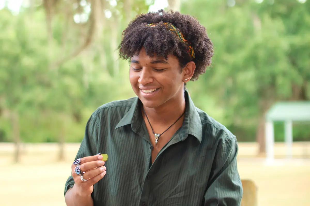 Young man smiling eating a full-spectrum CBD gummy from Natural Ways CBD