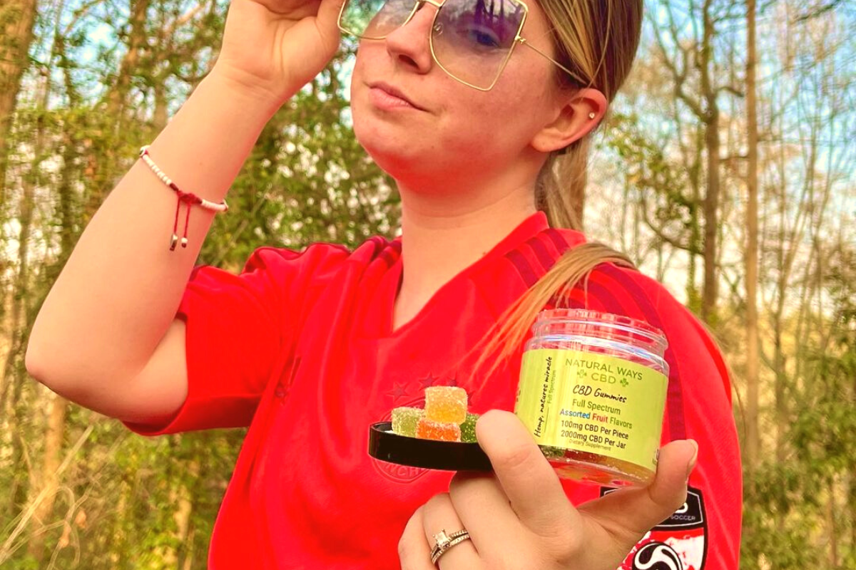 Woman holding natural ways CBD gummies