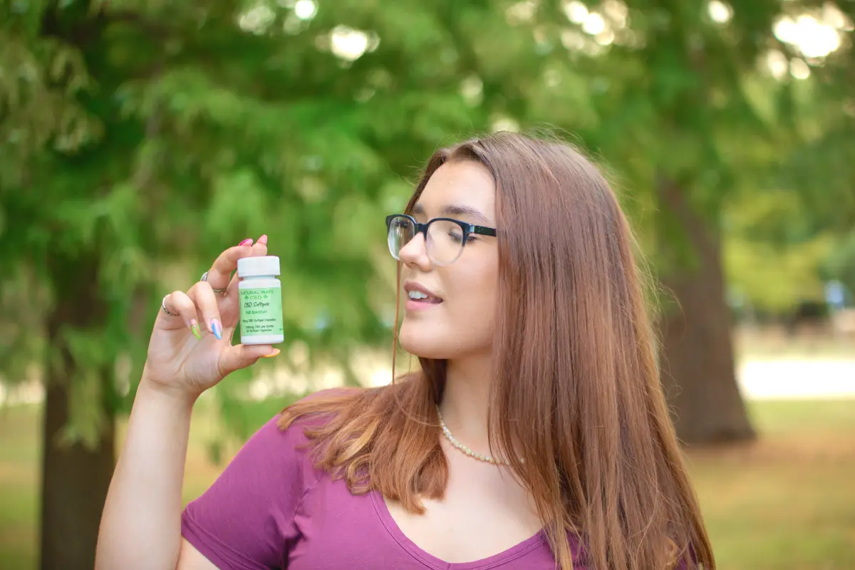 Young woman with natural ways CBD capsules softgels